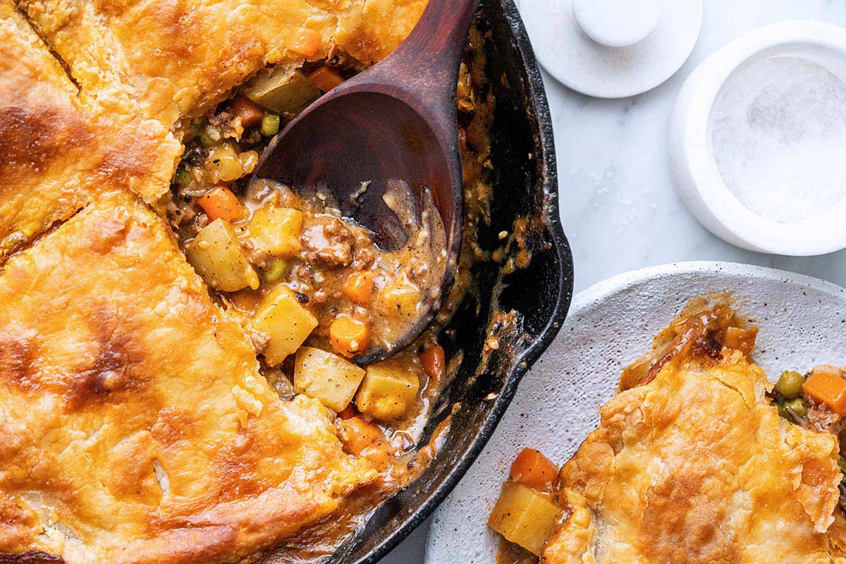 beef pot pie in skillet with flaky buttery top crust