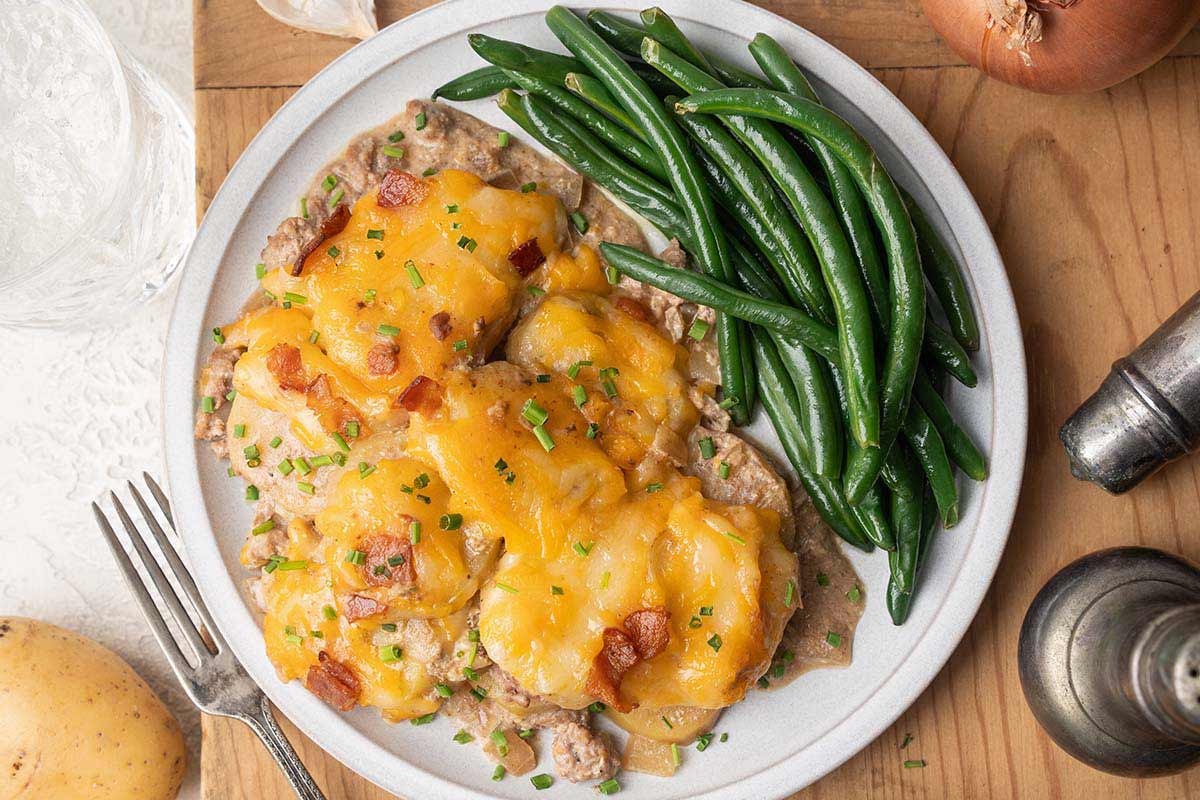 close up top view of crockpot cheesy hamburger potato casserole on plate