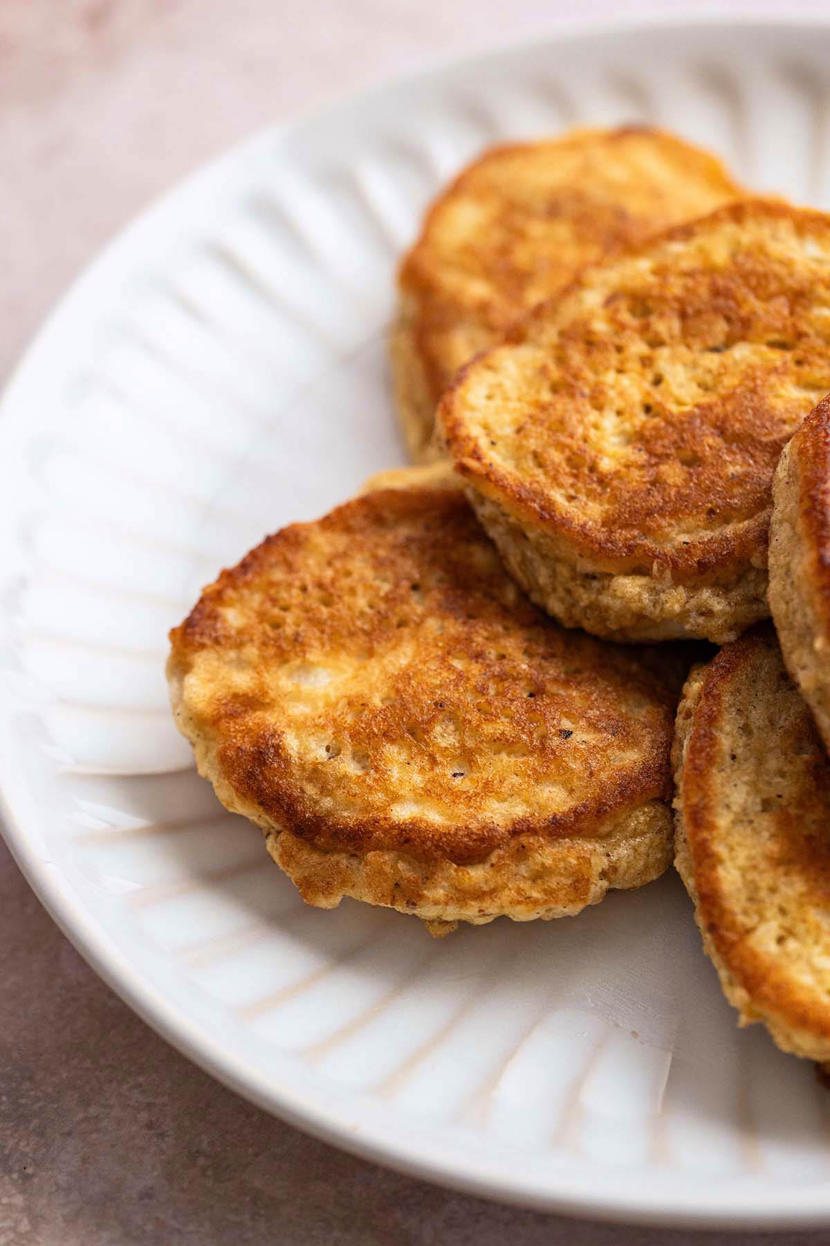 close up of crispy matzo meal latkes on white plate