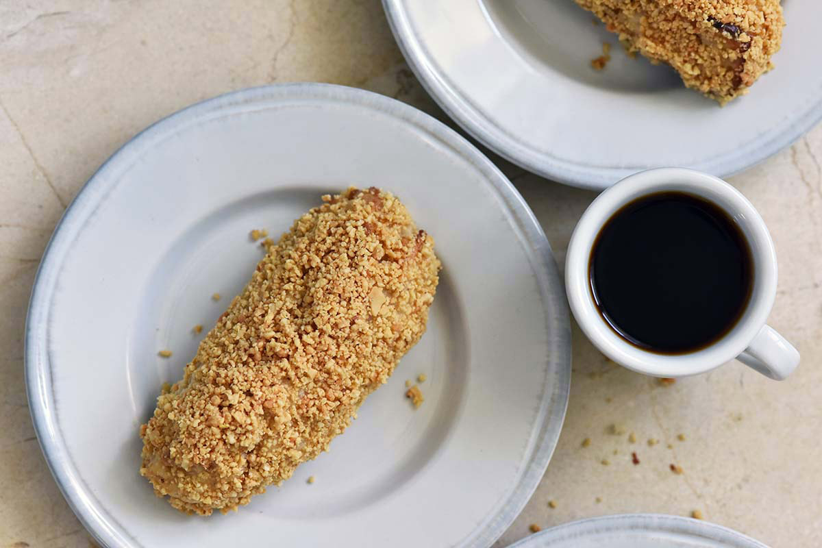 peanut sticks on doughnut shop plates with cup of coffee