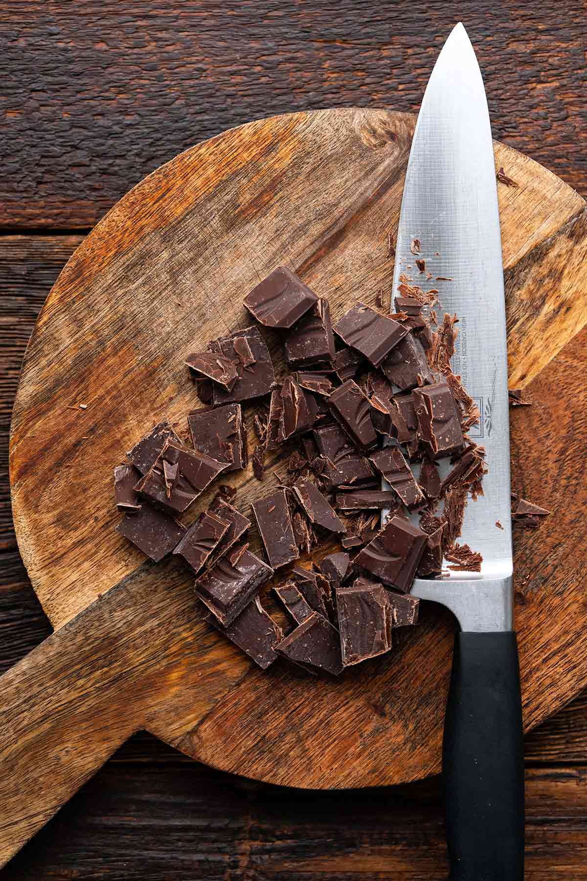 chopped good quality dark chocolate on wooden cutting board
