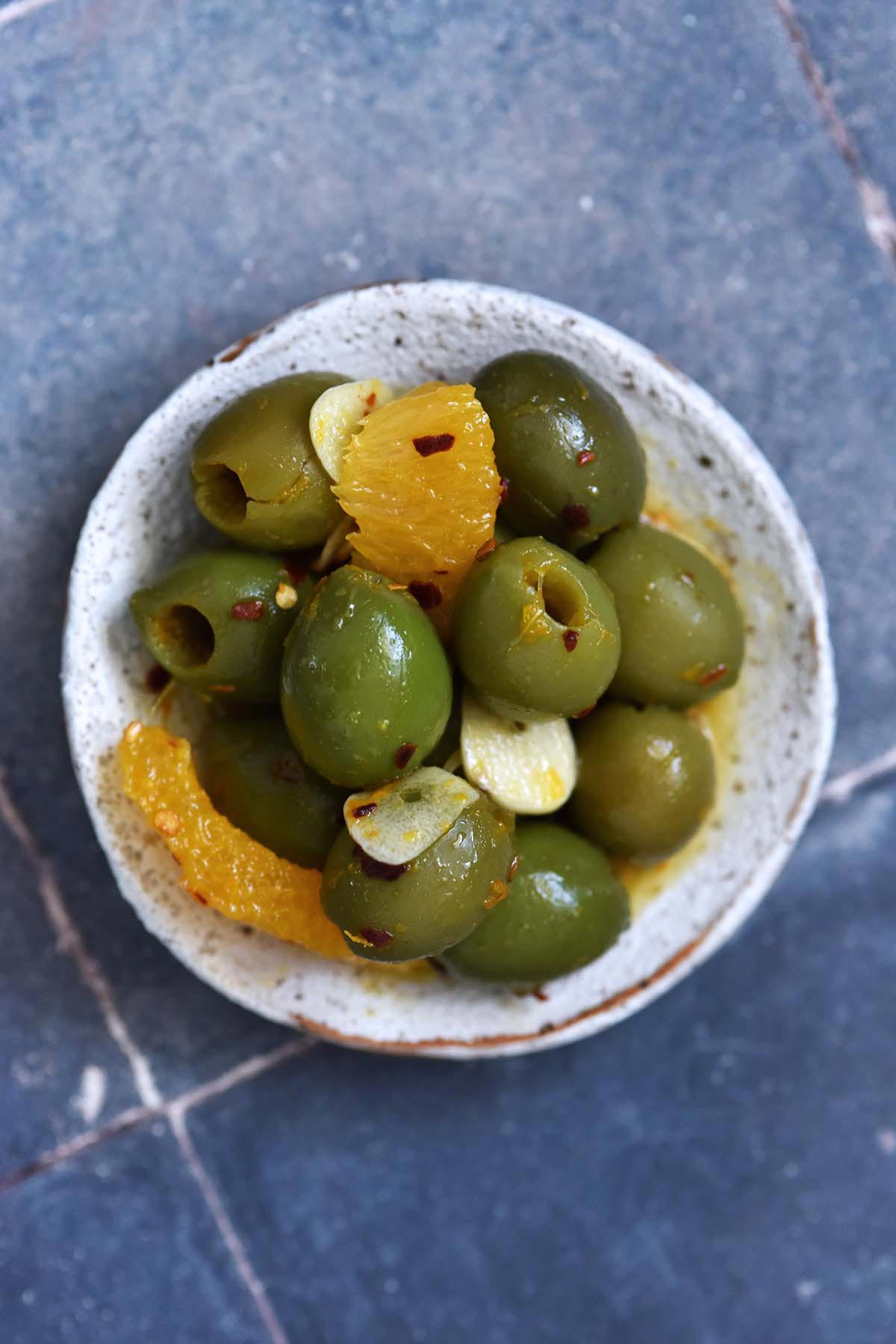 homemade gourmet zesty olive mix on stoneware plate