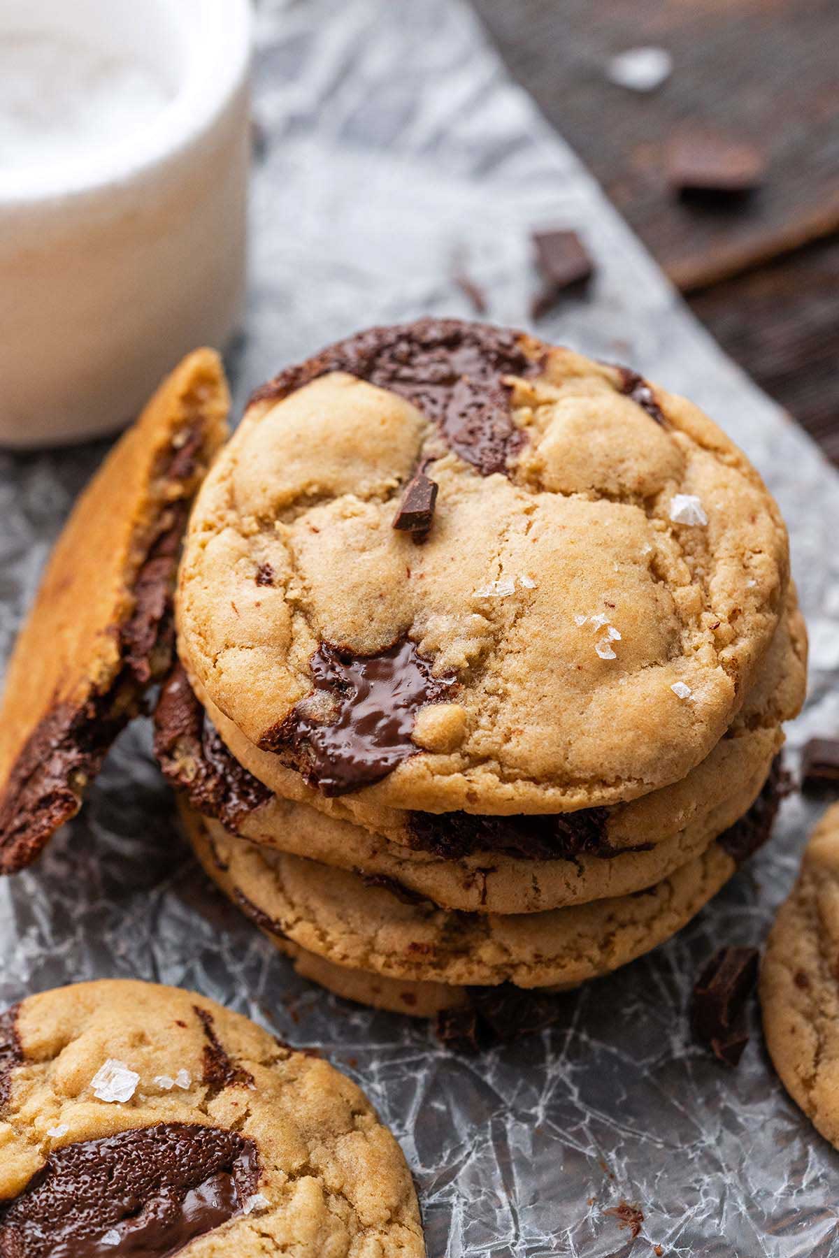 stack of brown butter sourdough chocolate chip cookies on wax paper