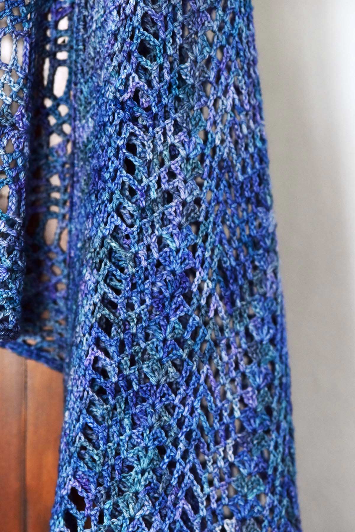 crochet women's shawl pattern in variegated blue Malabrigo colorway