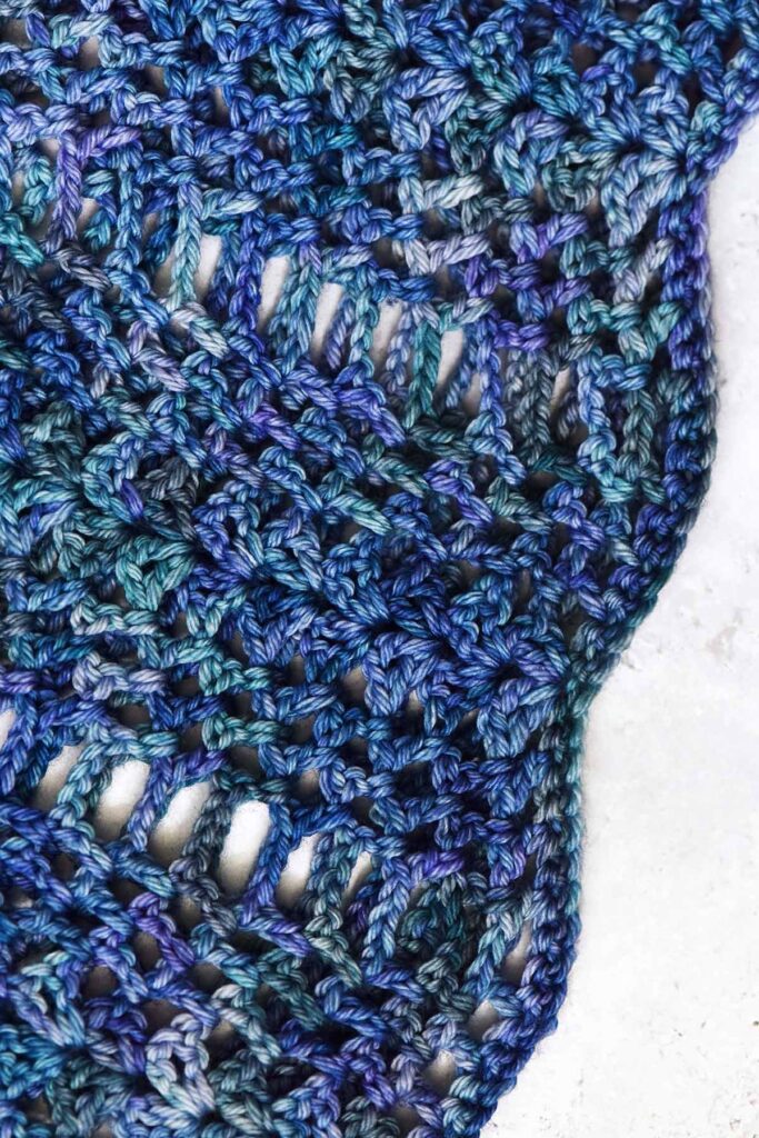 drapy rectangle crochet shawl in ripple pattern made with blue variegated Malabrigo yarn