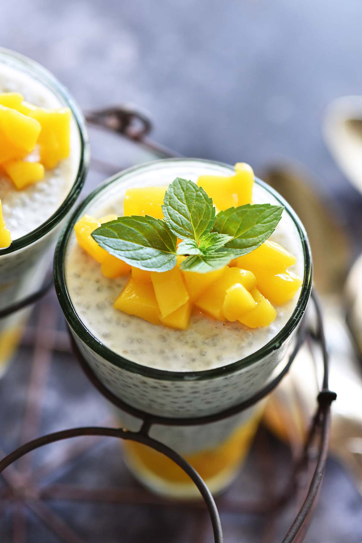 mango chia pudding in vintage glass in wire holder