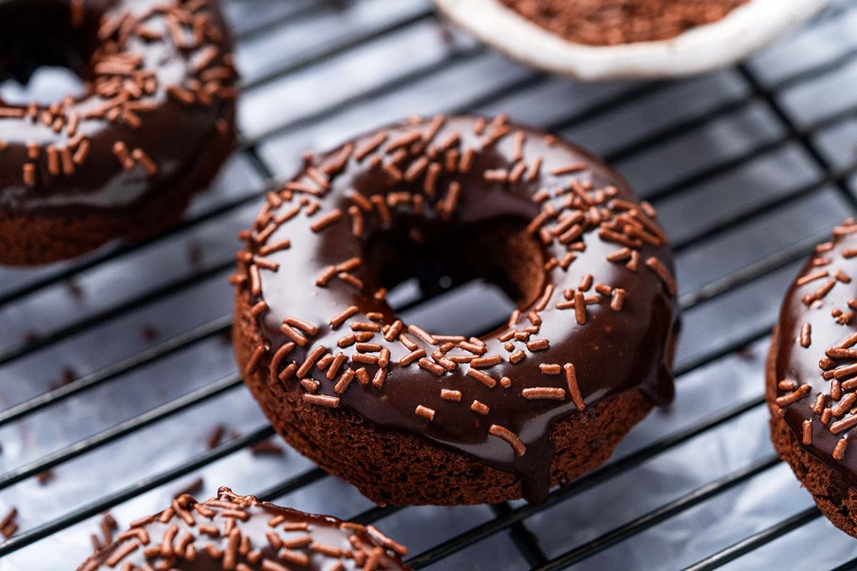 chocolate donut with icing and sprinkles