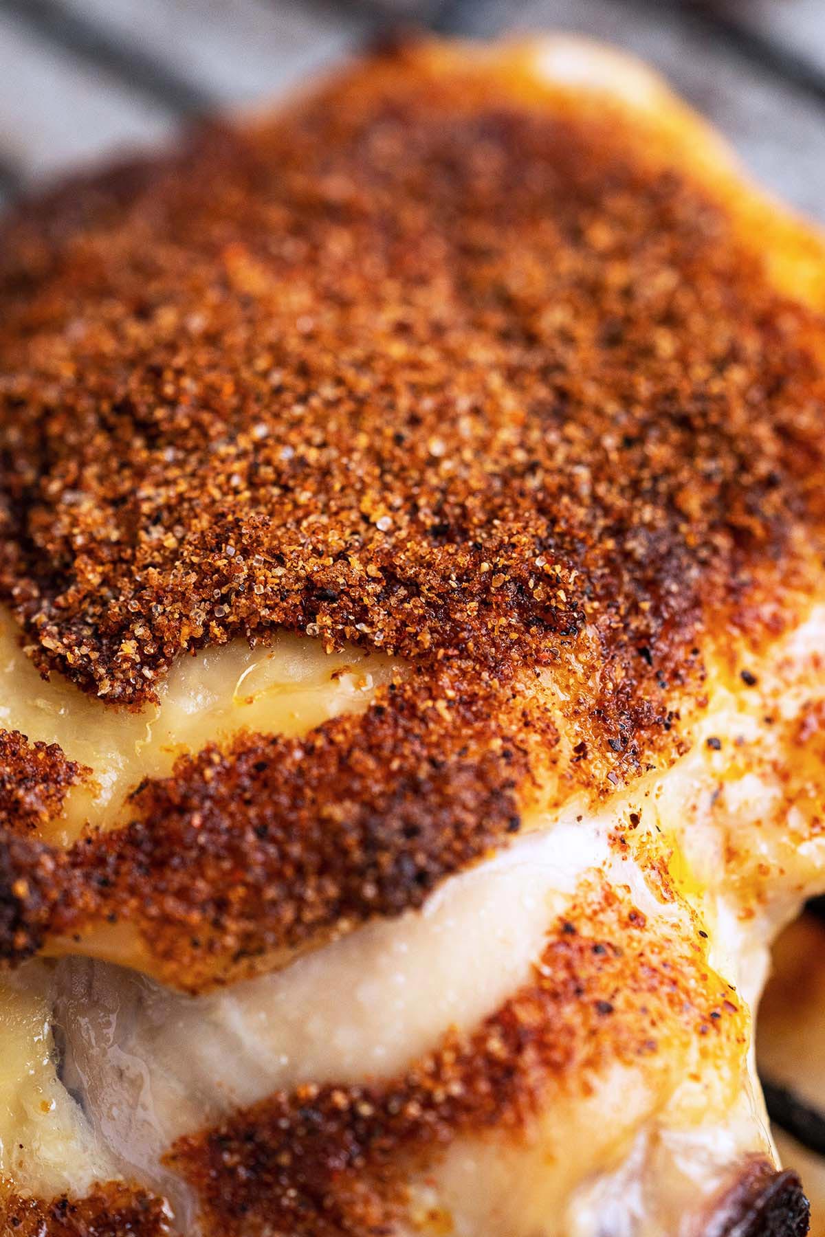 close up of tender juicy bbq chicken thigh baked in oven