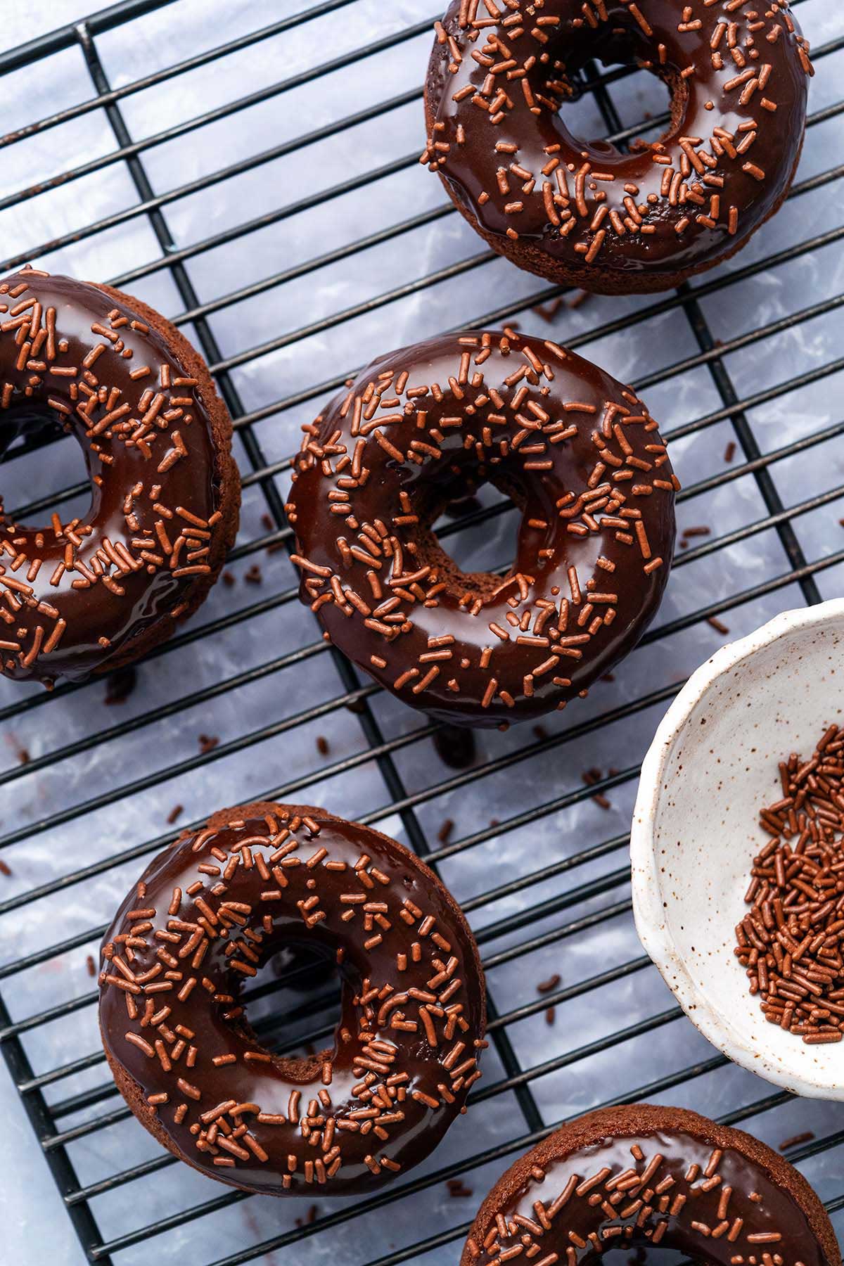 double chocolate doughnuts on wire rack