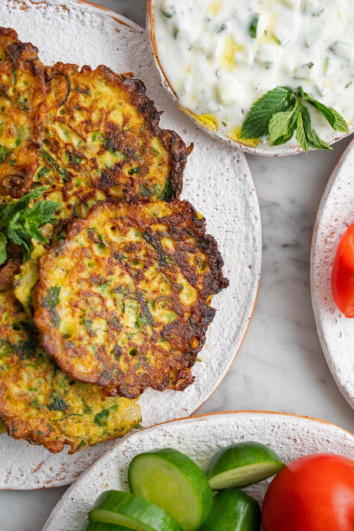 fried zucchini fritters with cucumber yogurt salad