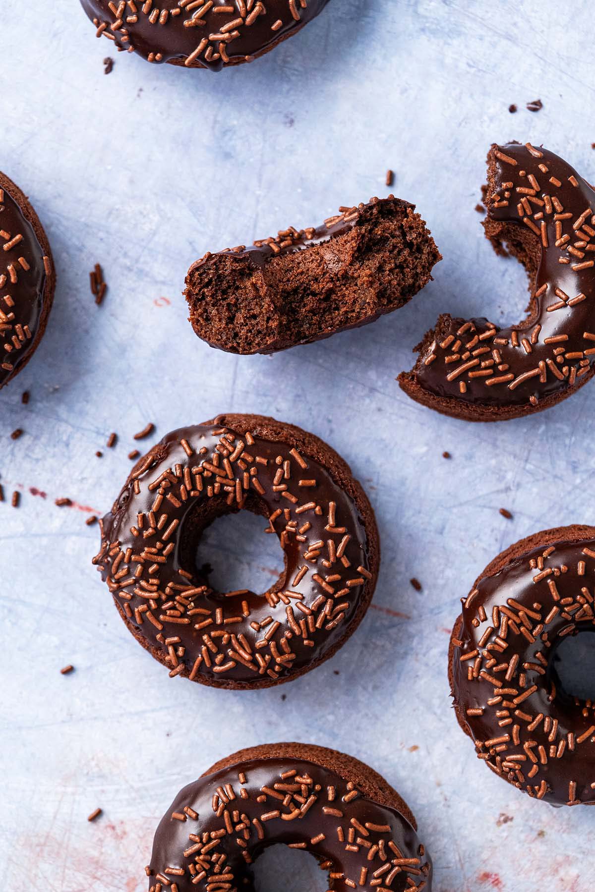 healthier glazed chocolate doughnuts on blue background