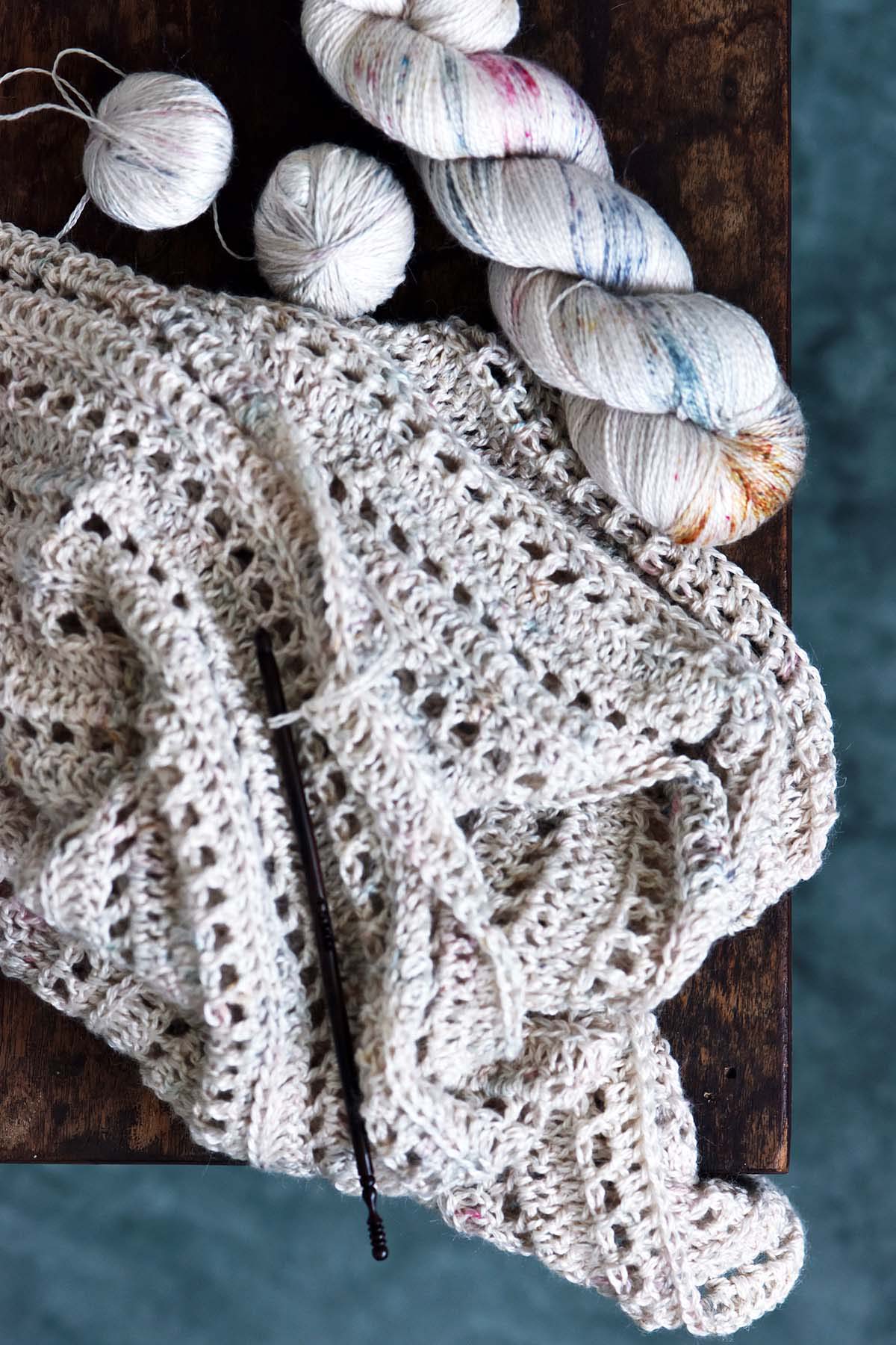 top view of lacy triangle shawl crochet project made with alpaca silk lace expression fiber arts yarn