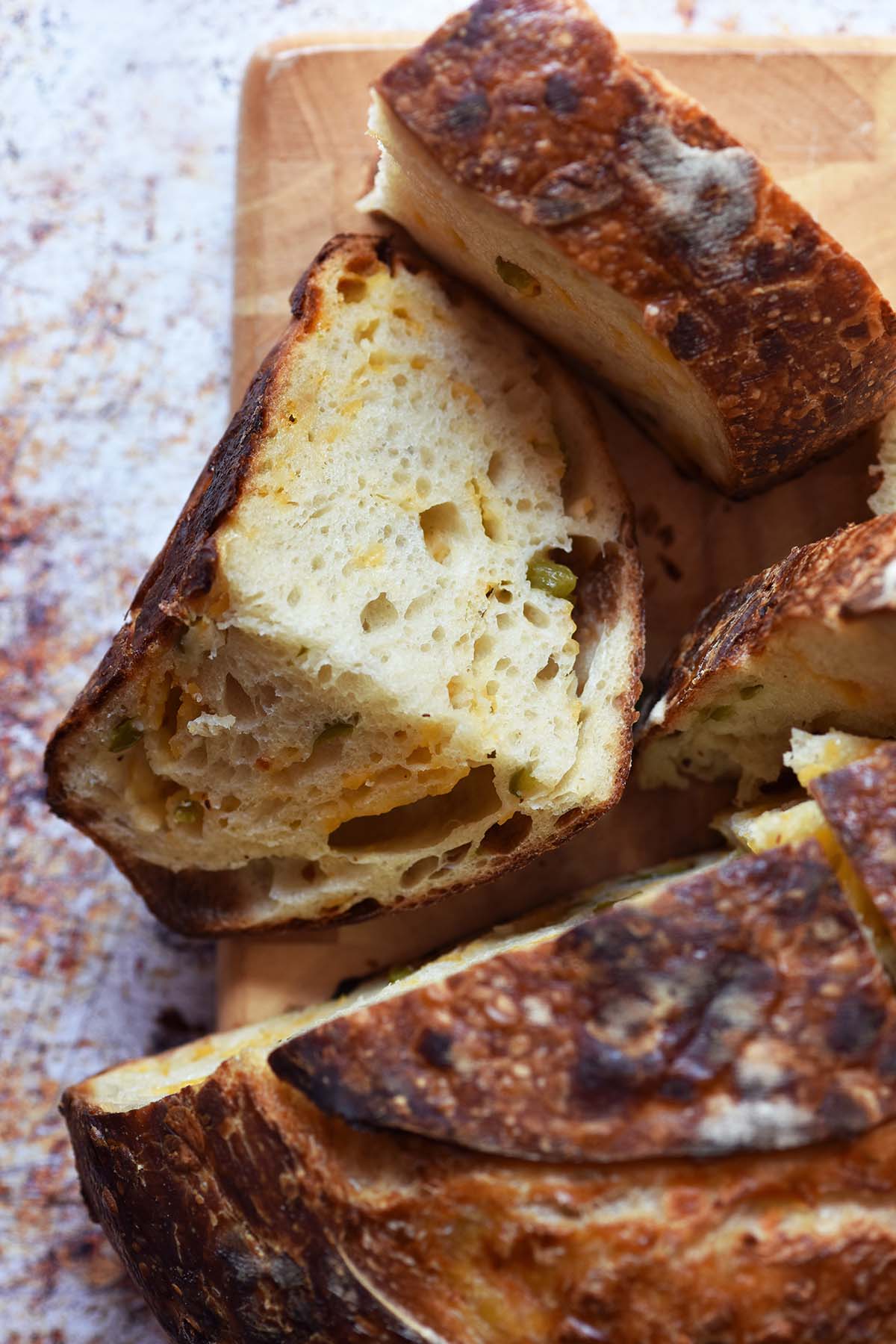 top view of sliced sourdough with savory inclusions on bread board
