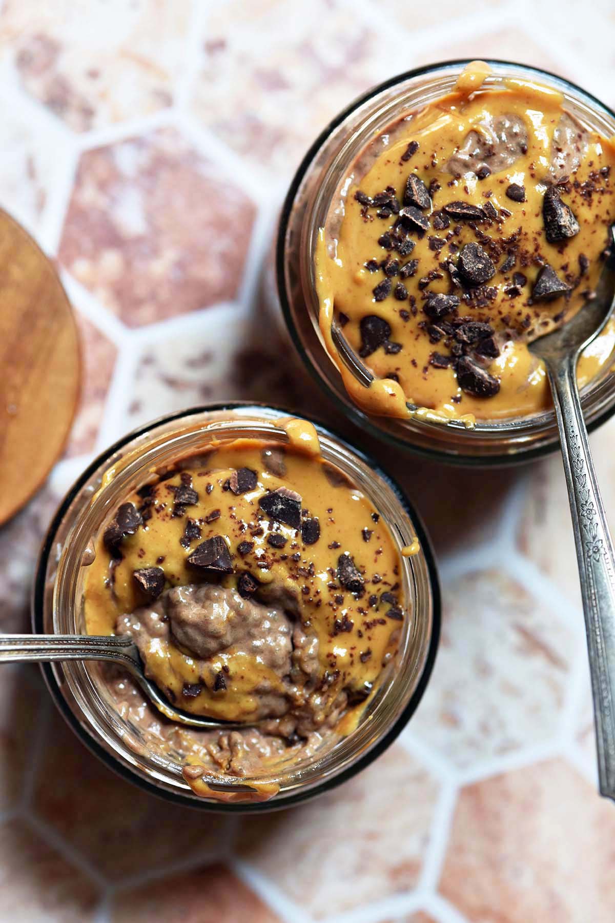 top view of two glass jars with meal prep overnight chia pudding