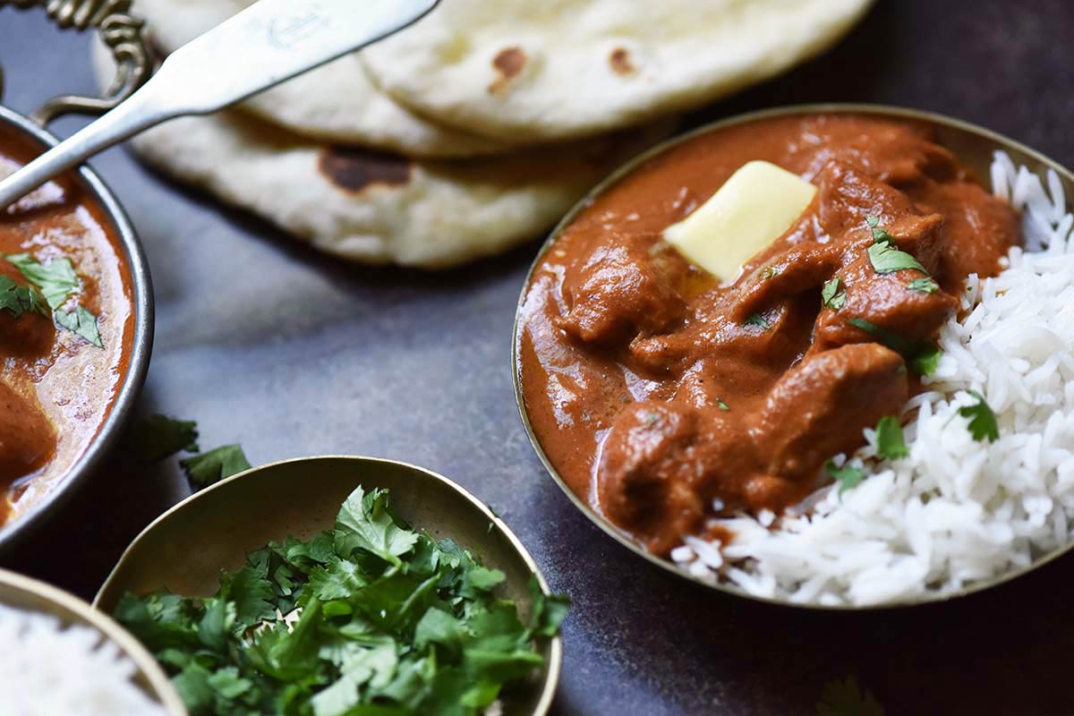 butter chicken with sauce and steamed basmati rice