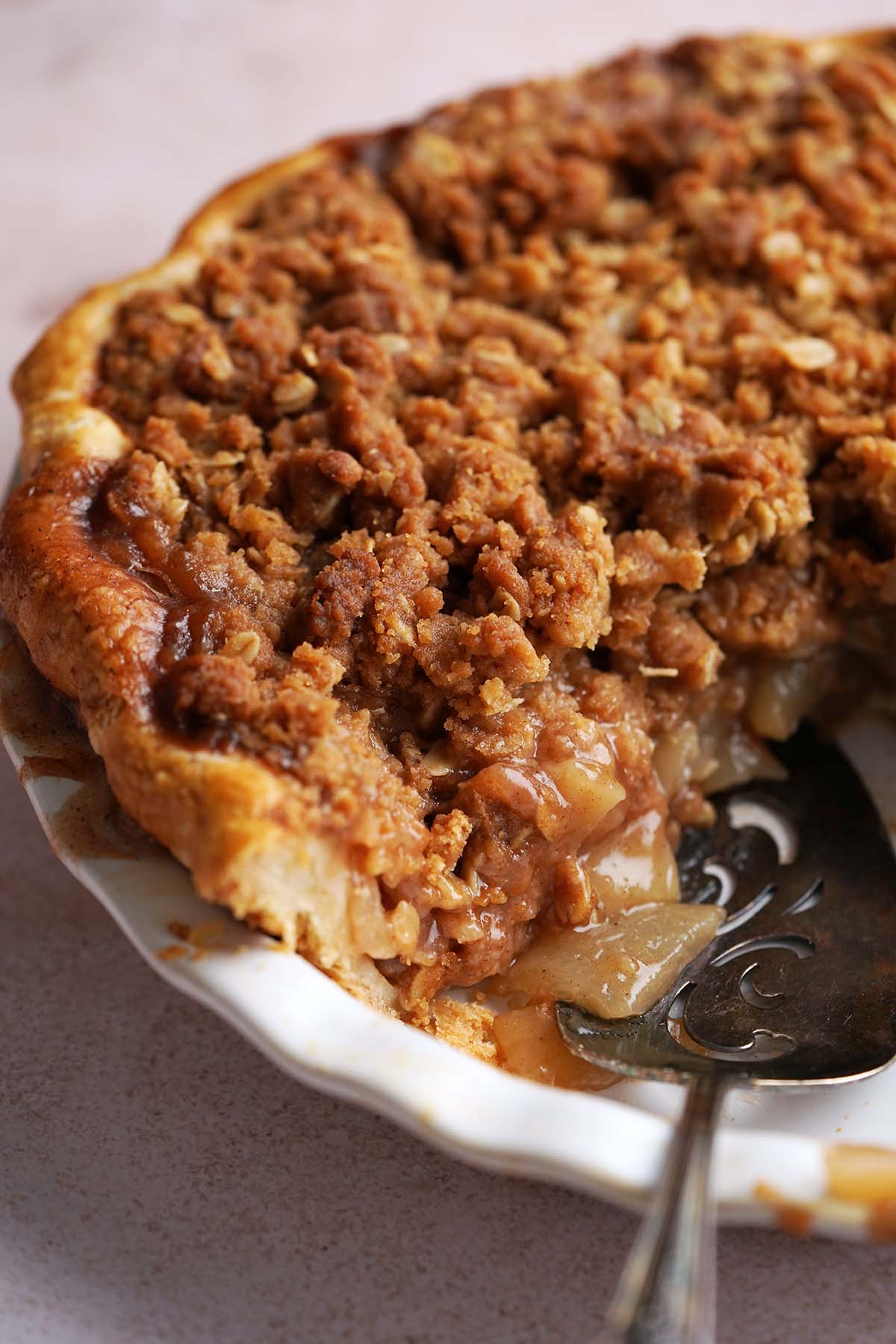 streusel topped pear pie with sourdough crust with slice removed to show juicy filling