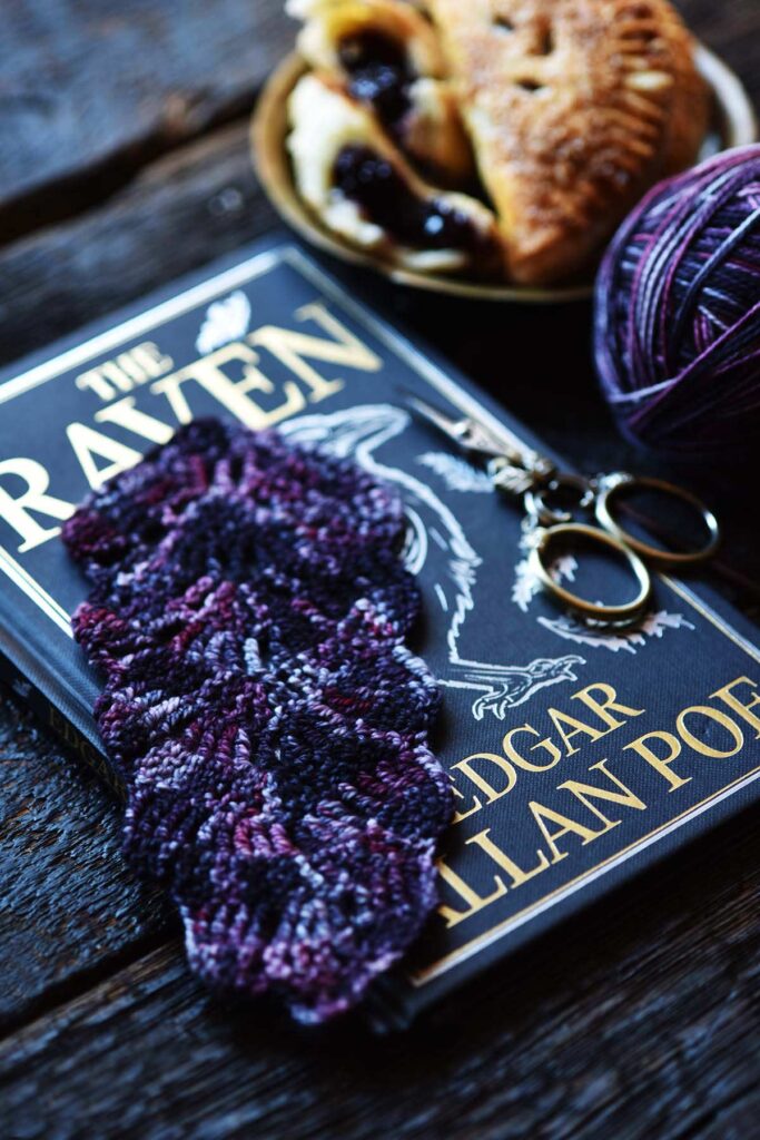crocheted feather bookmark in blackberry colors