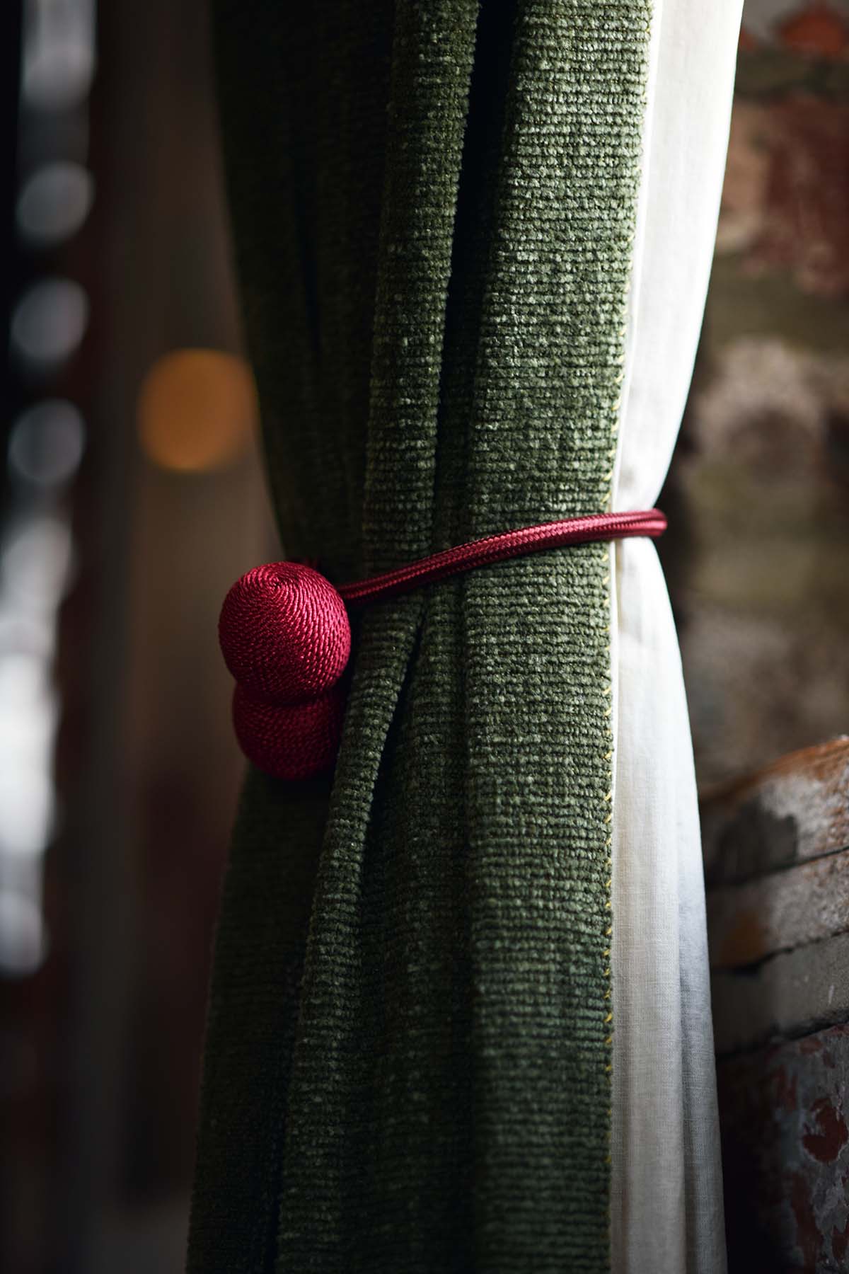 green curtains with decorative red ties at DIYA