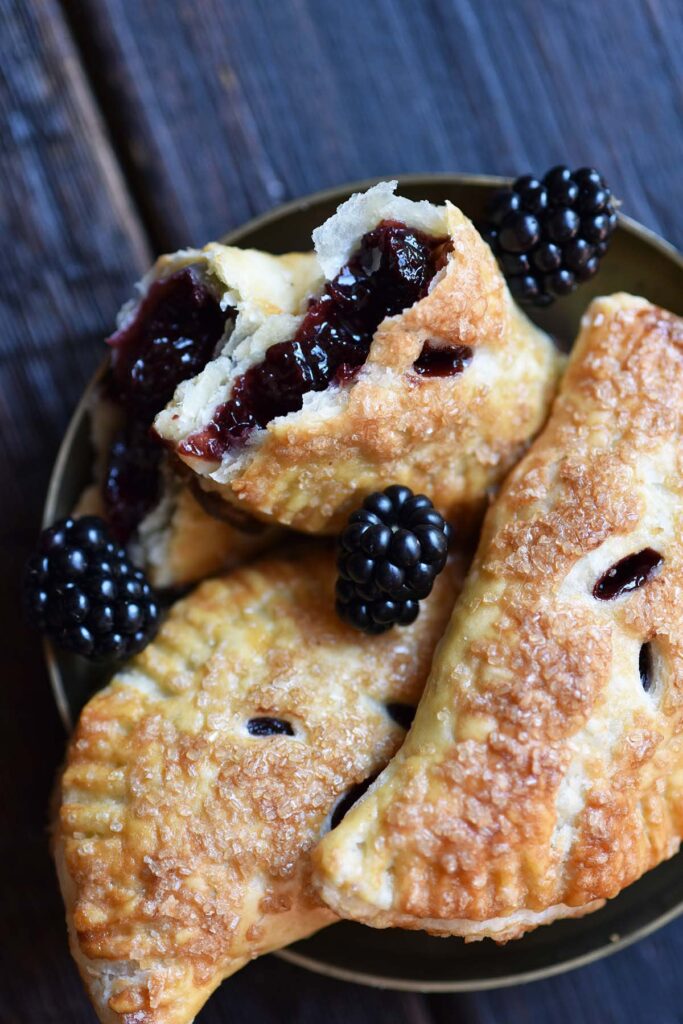 top view of blackberry tarts with flaky butter crust