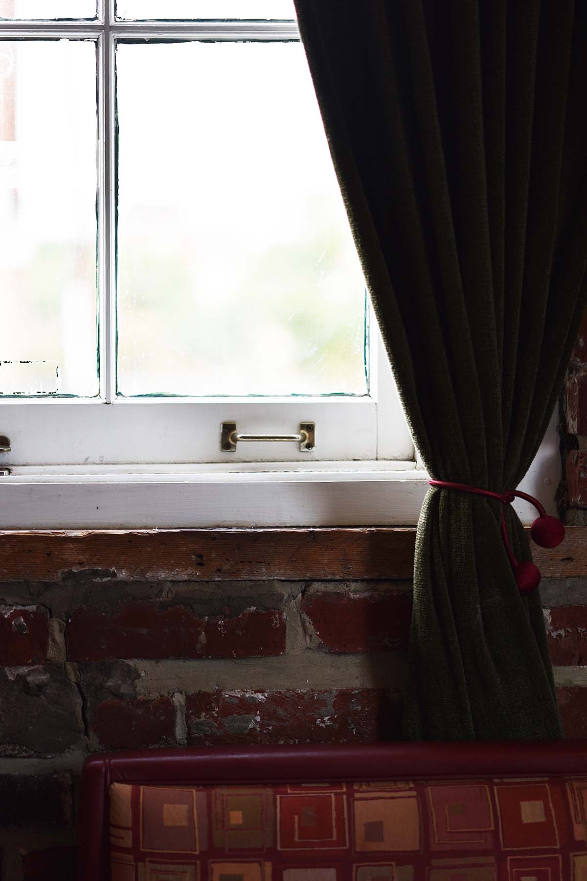 window and exposed brick wall at DIYA